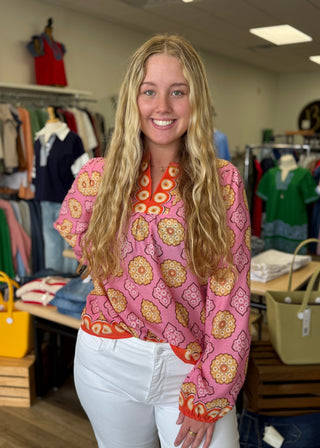 Woman wearing a pink patterned sweater in a clothing store